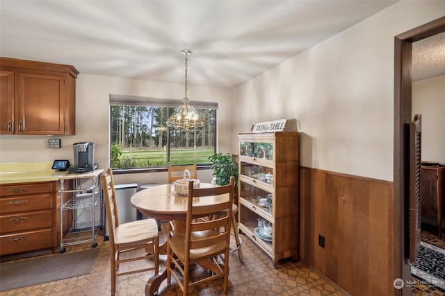 dining space with tile flooring and a chandelier