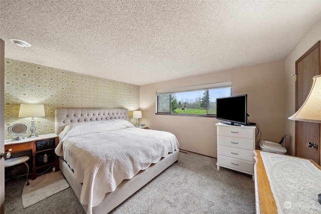 bedroom featuring carpet and a textured ceiling