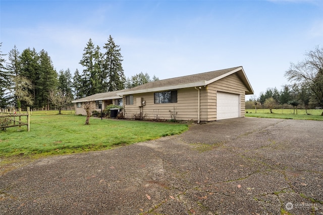 view of front of home featuring a garage and a front yard