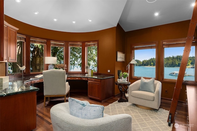 interior space featuring a water view, plenty of natural light, and light hardwood / wood-style floors