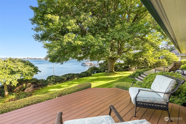 wooden deck featuring a yard and a water view