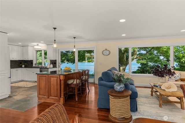 living room with dark hardwood / wood-style flooring, plenty of natural light, and crown molding