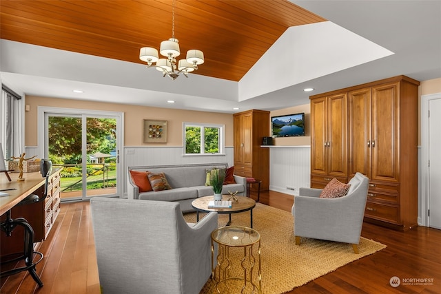 living room featuring an inviting chandelier, dark hardwood / wood-style floors, and lofted ceiling