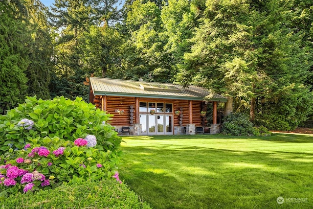 exterior space featuring french doors and a lawn