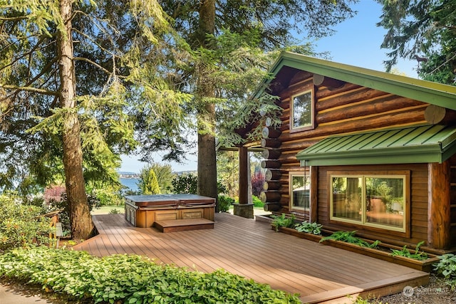 wooden terrace featuring a covered hot tub