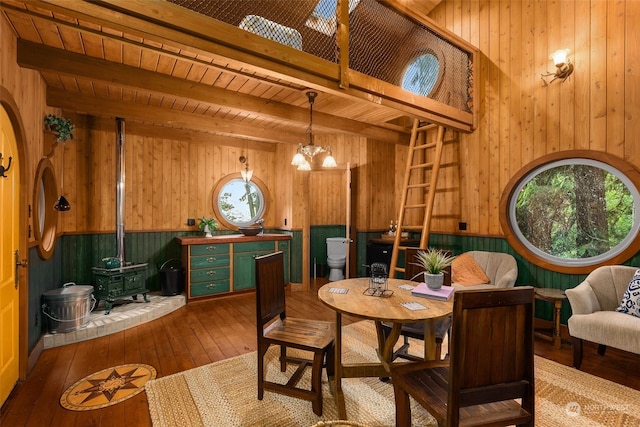 interior space featuring wood walls, beam ceiling, dark hardwood / wood-style floors, and wood ceiling