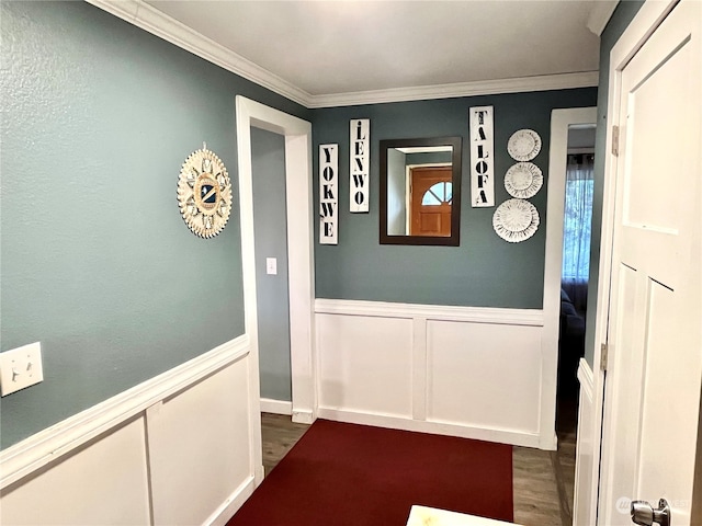 corridor with ornamental molding and dark wood-type flooring