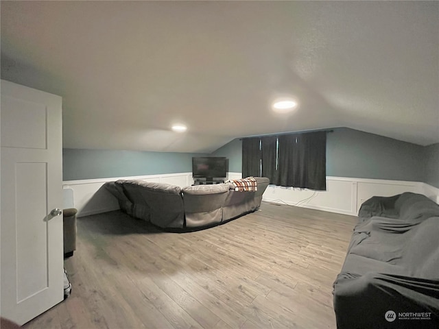 interior space with lofted ceiling and light wood-type flooring