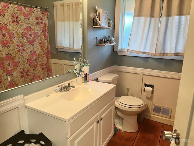 bathroom with tile flooring, toilet, and large vanity