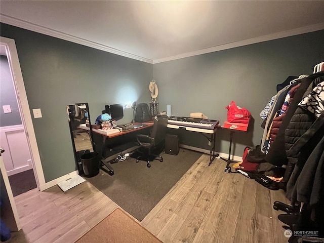 office area featuring light wood-type flooring and crown molding