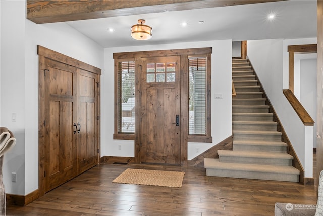 entryway featuring dark hardwood / wood-style flooring and beamed ceiling