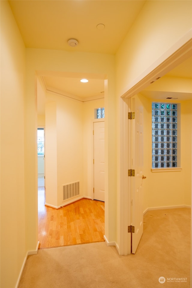 hallway with light colored carpet