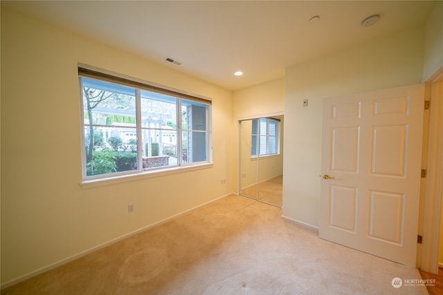 carpeted empty room featuring plenty of natural light