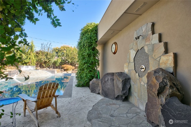 view of patio with a fenced in pool