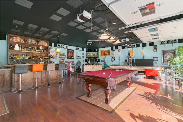 recreation room featuring pool table, wood-type flooring, and bar