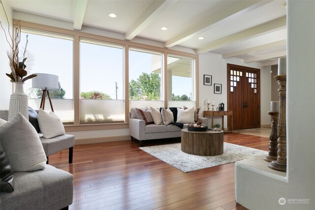 living room featuring beamed ceiling and hardwood / wood-style floors