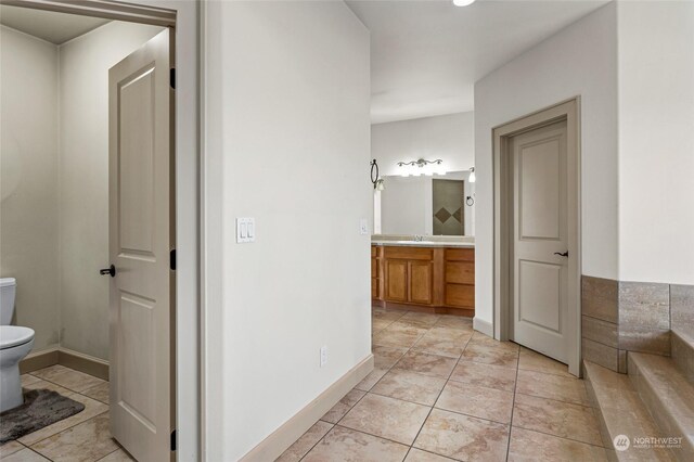 bathroom with tile patterned floors, vanity, and toilet