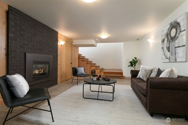 tiled living room featuring a large fireplace