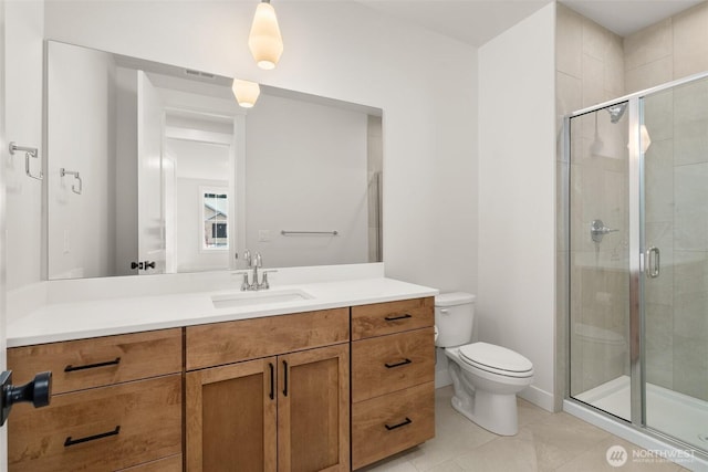 bathroom with toilet, a shower stall, tile patterned flooring, and vanity