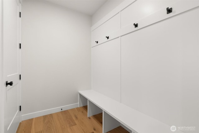 mudroom with light wood-style flooring and baseboards