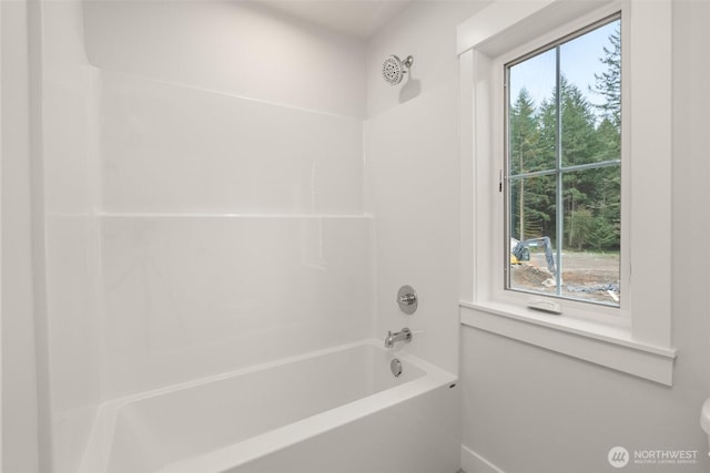 bathroom with bathing tub / shower combination and a healthy amount of sunlight