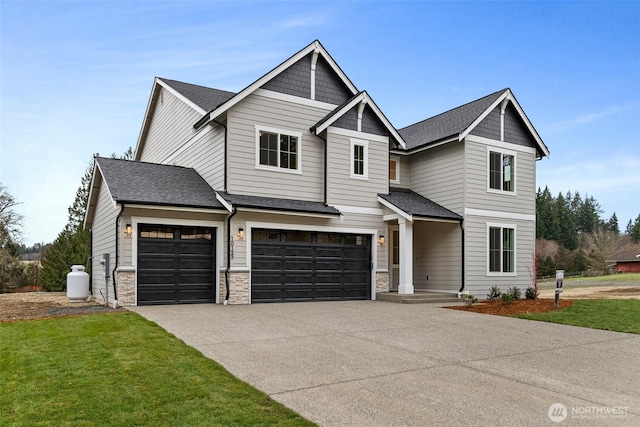 craftsman-style house with a garage, concrete driveway, stone siding, roof with shingles, and a front yard