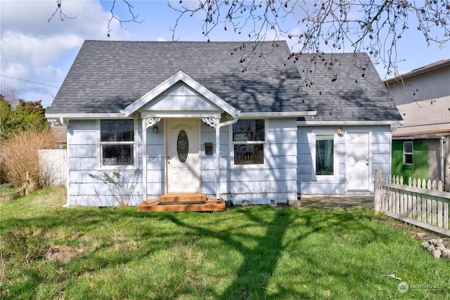 bungalow-style house with a front lawn