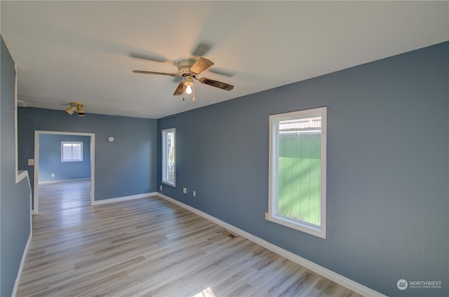 spare room with ceiling fan and light hardwood / wood-style flooring