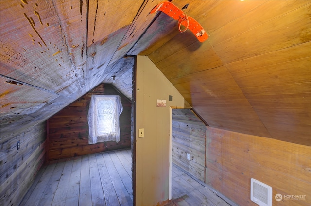 bonus room featuring wooden ceiling, lofted ceiling, dark hardwood / wood-style floors, and wooden walls