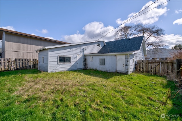 rear view of house with a lawn