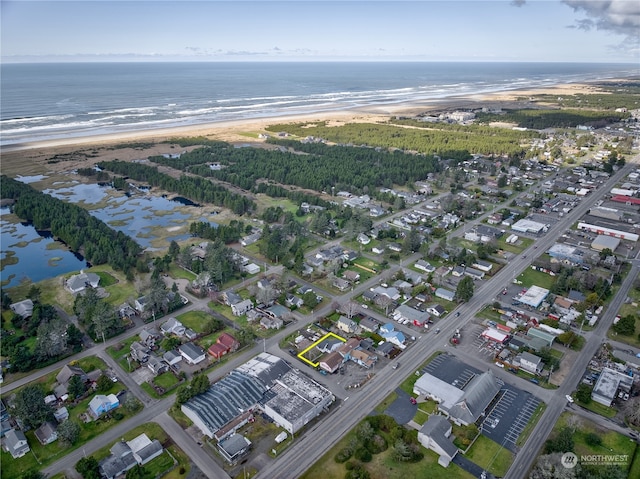 drone / aerial view with a water view and a view of the beach