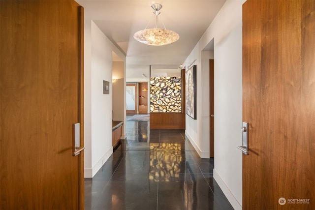 hall featuring dark tile flooring