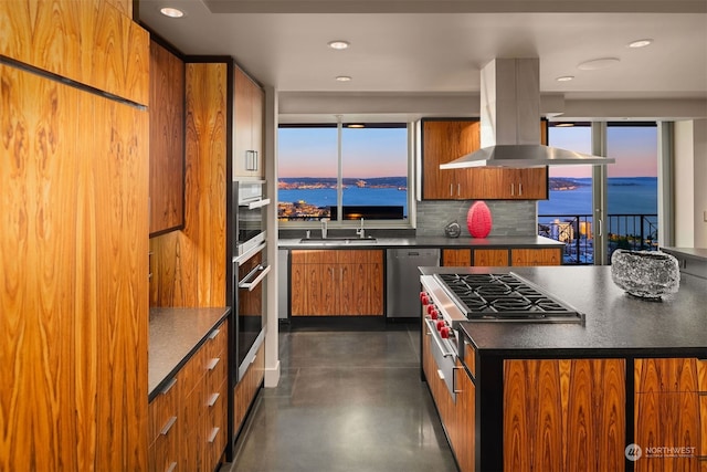 kitchen with backsplash, a water view, appliances with stainless steel finishes, and island exhaust hood