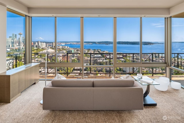 sunroom / solarium featuring a water view