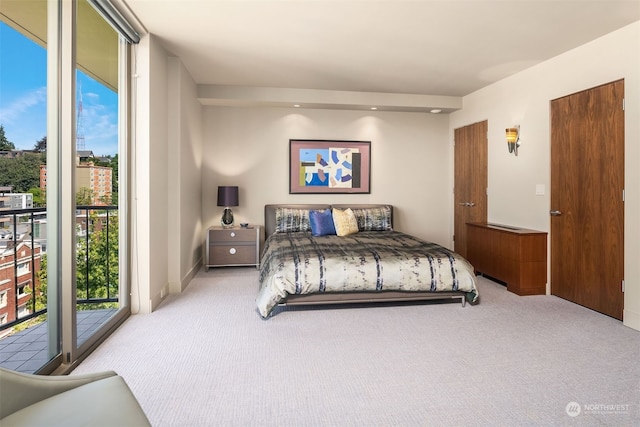 carpeted bedroom with access to exterior