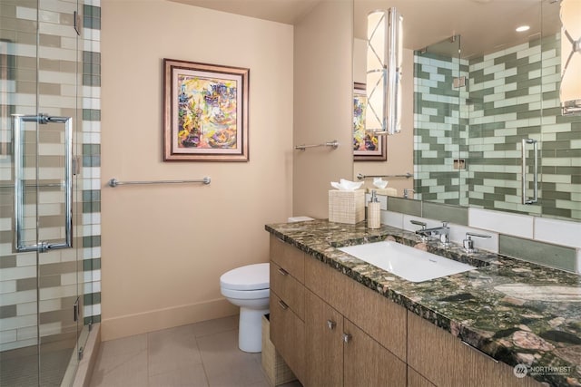 bathroom featuring walk in shower, tile flooring, toilet, and vanity