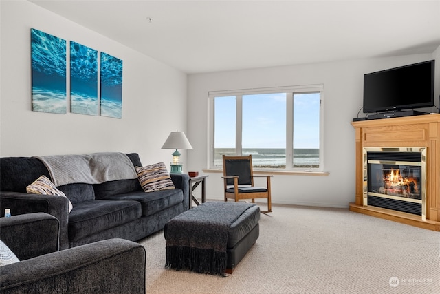 living room with light carpet and a water view