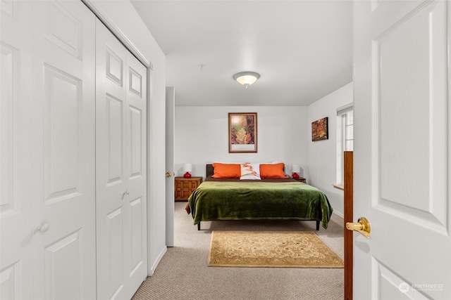 bedroom featuring light carpet and a closet