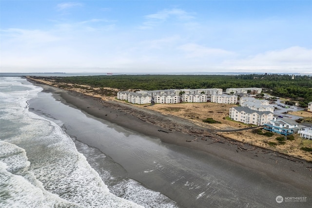 exterior space with a water view and a beach view