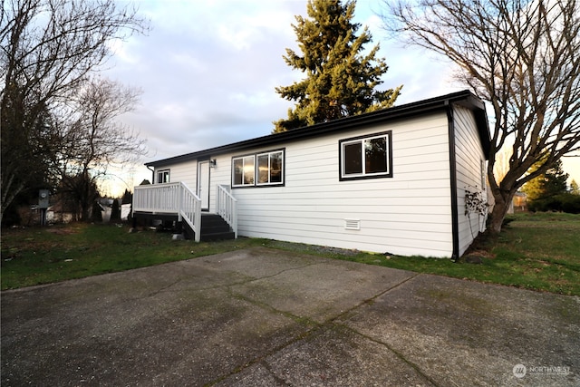 exterior space featuring a front yard and a deck