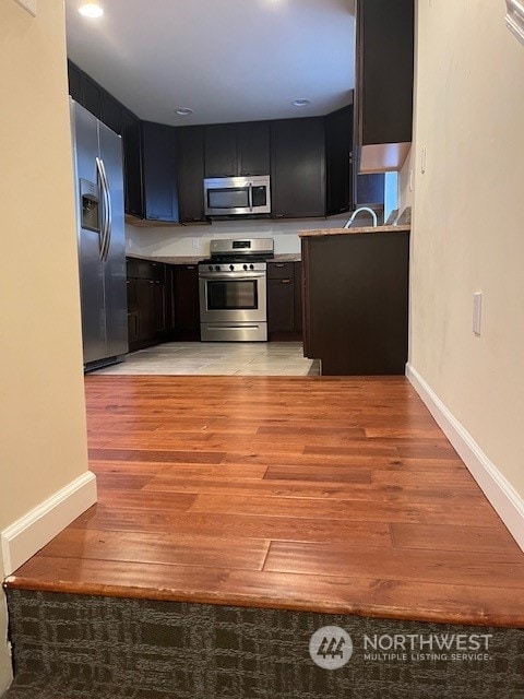 kitchen with light tile flooring, appliances with stainless steel finishes, and sink