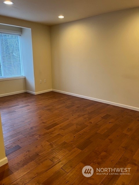 empty room featuring dark hardwood / wood-style flooring