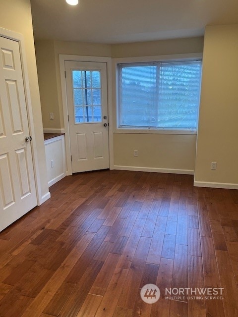 unfurnished room featuring dark hardwood / wood-style flooring