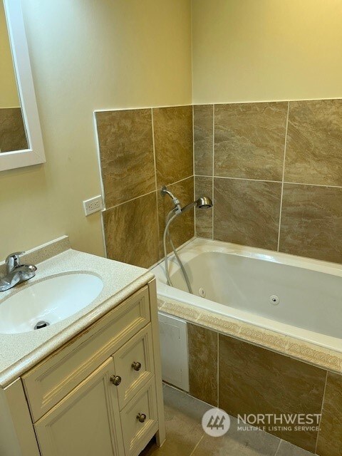 bathroom featuring tile flooring and oversized vanity