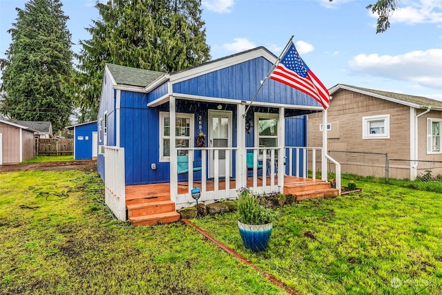 rear view of property with a lawn