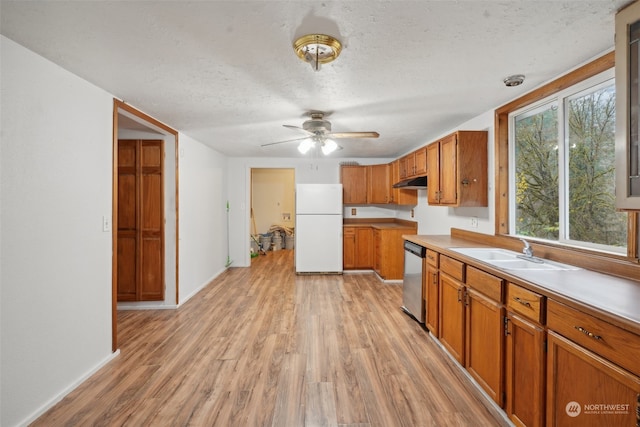 kitchen featuring dishwasher, white refrigerator, light hardwood / wood-style floors, and sink