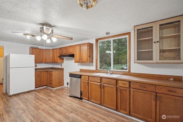 kitchen featuring dishwasher, a textured ceiling, white refrigerator, and sink