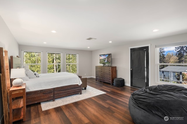 bedroom with dark hardwood / wood-style flooring