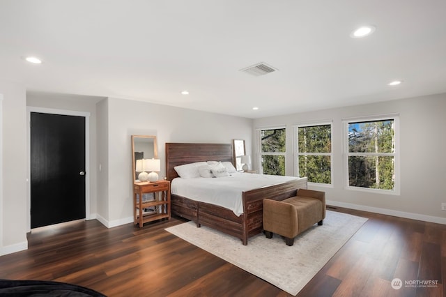 bedroom with dark hardwood / wood-style flooring