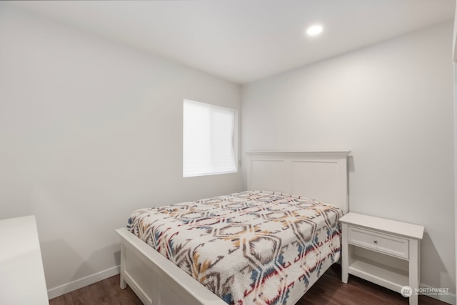 bedroom with dark hardwood / wood-style flooring